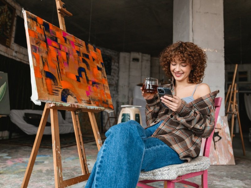 An artist using social media during her work break